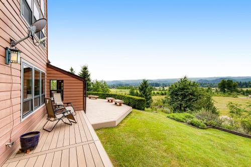 a backyard with a deck with a view of a field at Valley Green in Enumclaw