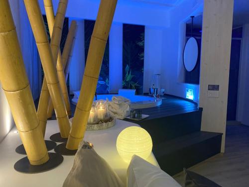 a room with a table with a lamp and bamboo at HOME 3 Luxury Suite in Bisceglie