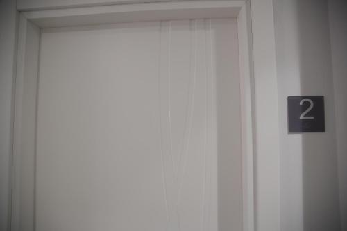 a door with a number sign in front of it at Valenti rooms & relax in Villaggio Mosè