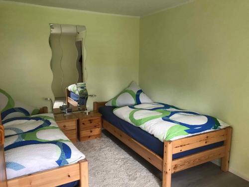 a bedroom with two twin beds and a mirror at Holiday home in Beelitz 2608 in Beelitz
