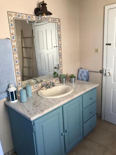 a bathroom with a sink and a mirror at Casa da Ponte in Baião