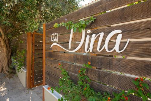 a sign that says uniah on a wooden wall at Casa Dina in Lefkada