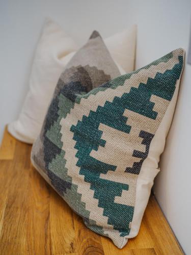 a pillow sitting on the floor next to a wall at Malom és Kacsa Boutique Hotel in Tata