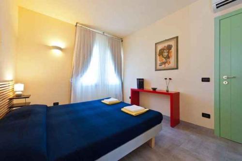 a bedroom with a blue bed and a window at Apartment in Lucca/Toskana 23961 in San Cassiano a Moriano
