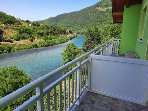 a balcony with a view of a river at Apartmani Vila na Drini in Foča
