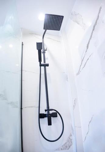 a shower in a bathroom with a laptop on the wall at Luxury Suites by Panagiota in Preveza
