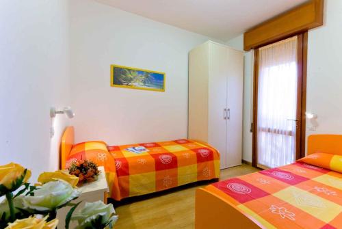 a hotel room with two beds and a window at Apartment in Bibione 24409 in Bibione
