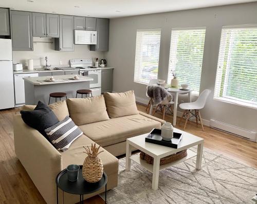 a living room with a couch and a kitchen at Cozy suite close to Nature and the City in Maple Ridge