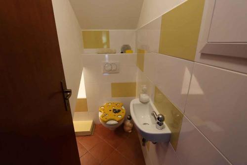 a small bathroom with a toilet and a sink at Silo Apartment 8 in Šilo