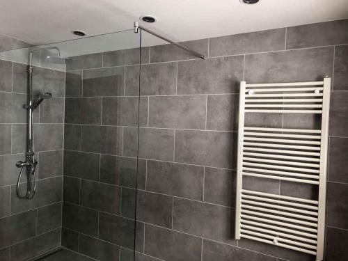a bathroom with a shower with a tiled wall at Holiday home in Kaltenbach/Zillertal 868 in Kaltenbach