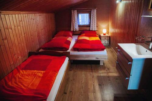 a room with three beds and a sink and a bathroom at Holiday home in Kaltenbach/Zillertal 868 in Kaltenbach
