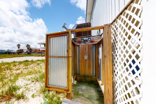 a wooden door on the side of a building at Take It Sea Z in Gulf Shores
