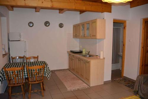 a kitchen with a table and a sink and a refrigerator at Apartment in Balatonbereny/Balaton 18075 in Balatonberény