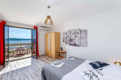 a bedroom with a bed and a view of the ocean at Studio Crikvenica 6 in Dramalj