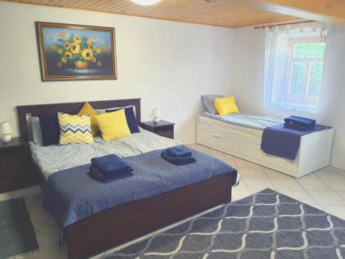a bedroom with two beds and a window at Dorci Vendégház - A piece of peace in Cserépfalu