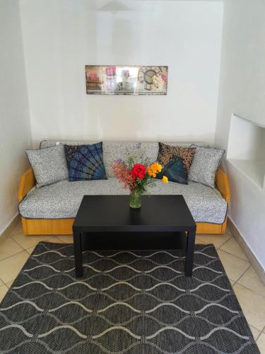 a living room with a couch and a table at Dorci Vendégház - A piece of peace in Cserépfalu