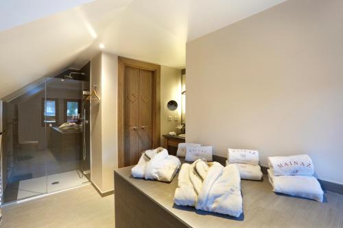a bathroom with white towels sitting on a counter at La Mainaz Hôtel Restaurant Genève - Gex - Mijoux in Gex