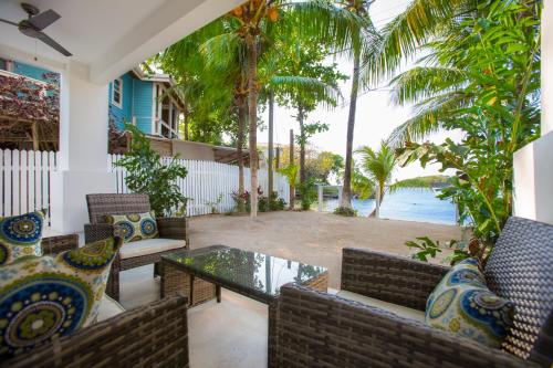 a patio with chairs and a table with a view of the water at Bella Luna Beach Condo #227462 in West End