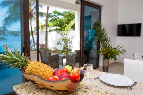 a bowl of fruit sitting on a table at Bella Luna Beach Condo #227462 in West End