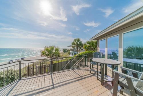 a balcony with a table and a view of the ocean at Nifty Shades Of Gray Home in Inlet Beach