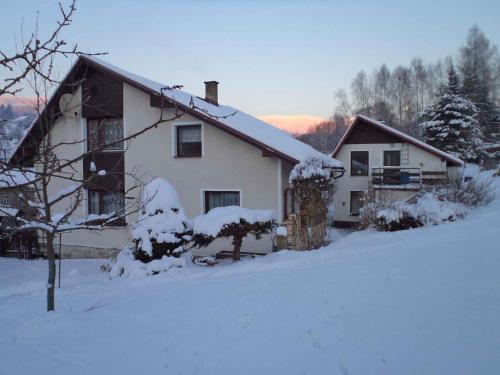 a white house with snow on the ground at Apartment in Rokytnice nad Jizerou 2102 in Rokytnice nad Jizerou