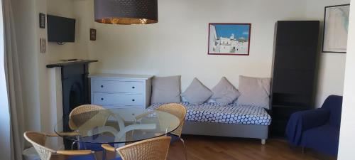 a living room with a glass table and a bed at Apartamentos Foz O Porto in Porto