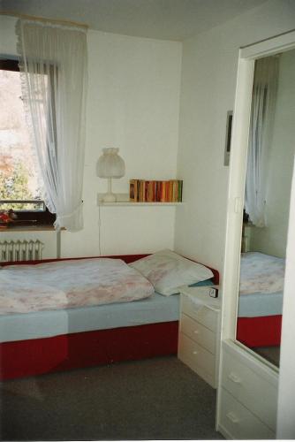a small bedroom with two beds and a window at Ferienwohnungen Mahlke in Berchtesgaden