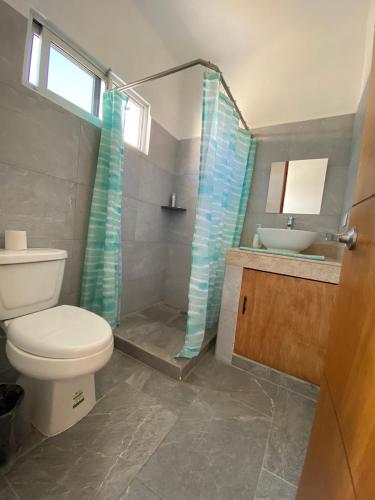 a bathroom with a toilet and a sink and a shower at Centrico Departamento 401 in Cancún