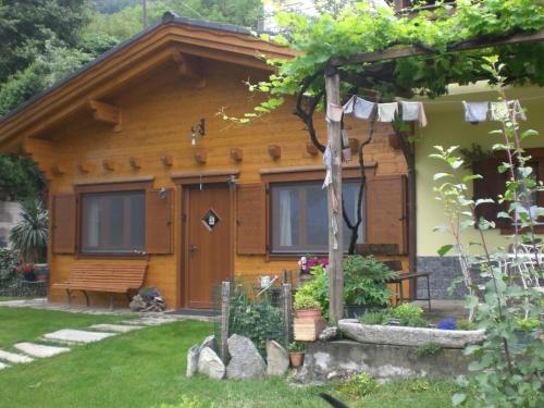 a wooden house with a fence in front of it at Pera Rionda in Caprie