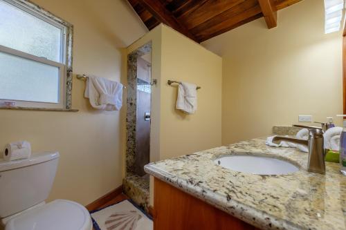 a bathroom with a sink and a toilet at Casa De Bonita Home in San Pedro