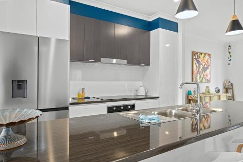 a kitchen with a stainless steel sink and a counter at Zion By The Sea - Aldinga Beach - C21 SouthCoast Holidays in Aldinga Beach