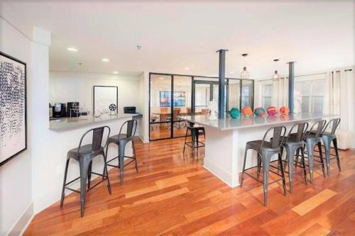 a kitchen with a bar with chairs in a room at Buckhead Blue - Spacious 2 bd 2ba - Private Balcony-Rooftop- S13 in Atlanta