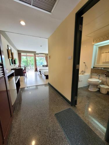 a large bathroom with a toilet and a sink at Aekpailin River Kwai Resort in Kanchanaburi City