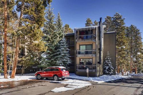 a red car parked in front of a house at Hot Tub & Sauna PEAK 8 BRECKENRIDGE in Breckenridge