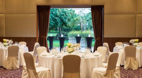 a room with white tables and chairs and a window at Radisson Blu Hotel, Abu Dhabi Yas Island in Abu Dhabi