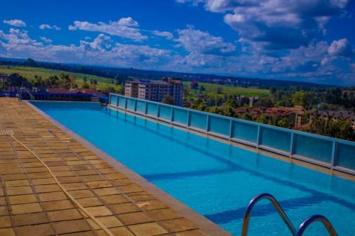 a swimming pool on the roof of a building at Maven Sparkles Furnished Apartments in Kiambu