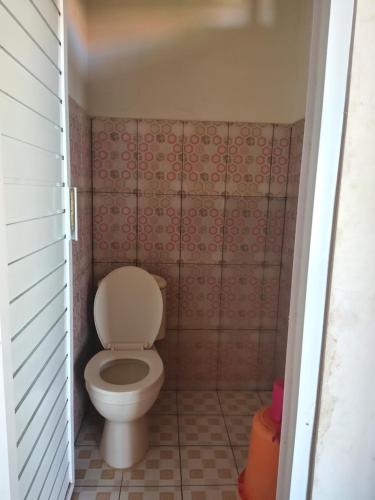 a bathroom with a toilet in a small room at Penginapan Karanglaut Sayangheulang in Cilauteureun