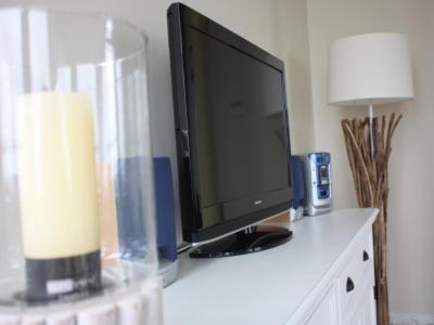 a computer monitor sitting on top of a desk at BadeWerk Appartements in Neuharlingersiel