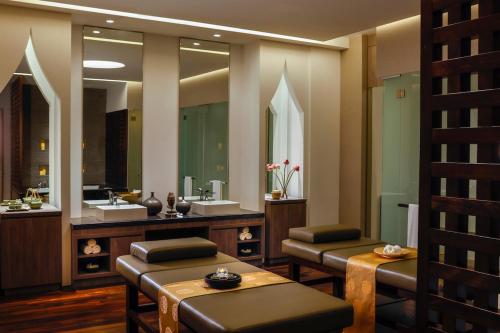 a bathroom with two sinks and a large mirror at Dusit Thani Laguna Singapore in Singapore