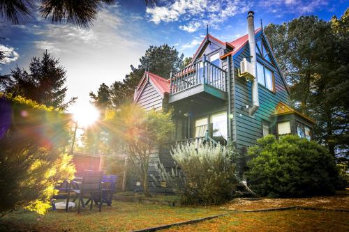 a house with the sun shining on it at Bells Estate Great Ocean Road Cottages in Torquay