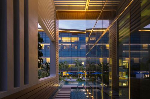 an external view of a building with a swimming pool at Dusit Thani Laguna Singapore in Singapore