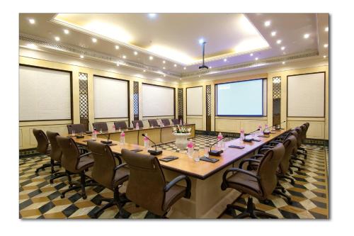 a large conference room with a long table and chairs at Shiv Vilas Resort in Jaipur