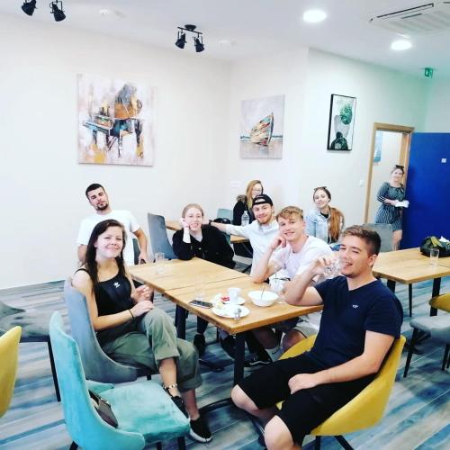 a group of people sitting at tables in a room at AI HOSTEL in Split