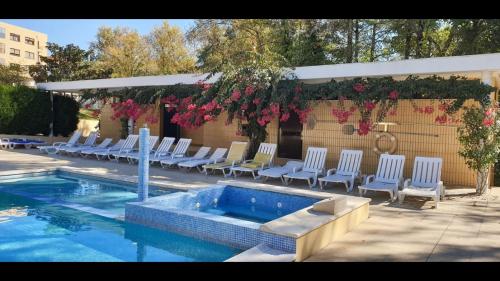 a group of chairs and a swimming pool at Apartamento Francelos Condominio in Vila Nova de Gaia