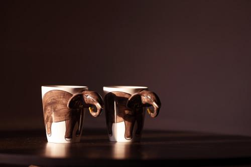 two cups with an elephant on top of them at Tuskers Hill by Poppys Anaikatti in Palghat