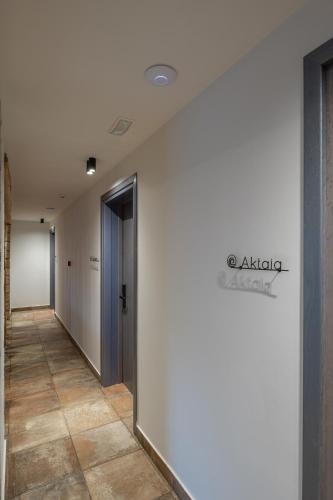 a hallway of an office building with a sign on the wall at NISSEA Boutique Hotel in Kardamaina
