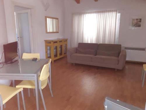 a living room with a couch and a table at Villa Imago in Roseto degli Abruzzi
