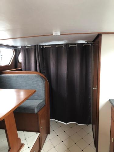 a room with a table and a black curtain at La Vedette Hollandaise in Étaples