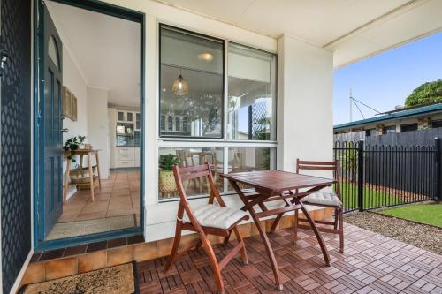 a patio with a table and chairs on a porch at Spacious Family Beach House in Caloundra