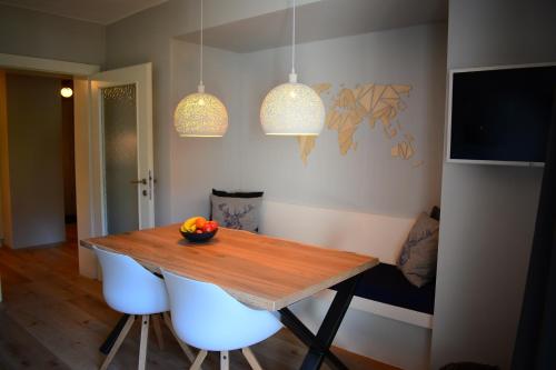 a dining room table with a bowl of fruit on it at Forest Mountain Apartment in Bad Kleinkirchheim